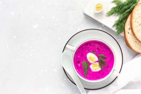 Delicious, healthy cold beetroot soup, decorated with egg and dill on a gray table. Diet food.の写真素材