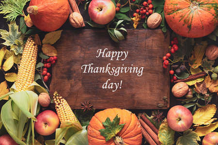 Autumn background of fallen leaves, pumpkins, corn, fruits and nuts. The concept of thanksgivingの写真素材