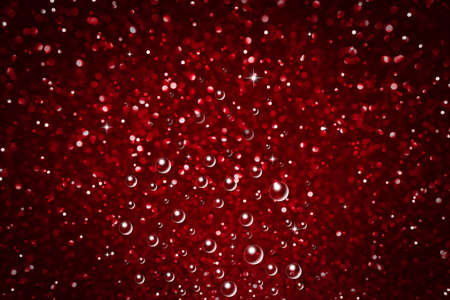 Red abstract defocused bokeh background. Sparkling texture.の写真素材