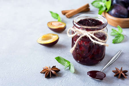 Plum jam and ingredients for its preparation: plums, cinnamon, star anise and mint. Autumn preparations.の写真素材