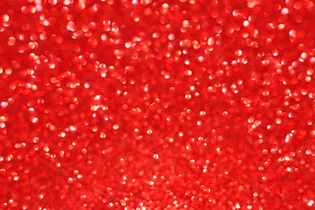 Red abstract defocused bokeh background. Sparkling texture.の写真素材