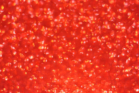 Red abstract defocused bokeh background. Sparkling textureの写真素材