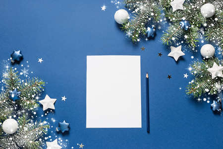 Christmas background. Xmas checklist or empty blank letter for Santa Claus on blue.の写真素材