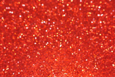 Red abstract defocused bokeh background. Sparkling texture.の写真素材