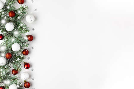 Christmas background with Xmas toys on a white wooden table. New Year card. Copy space, flat lay.