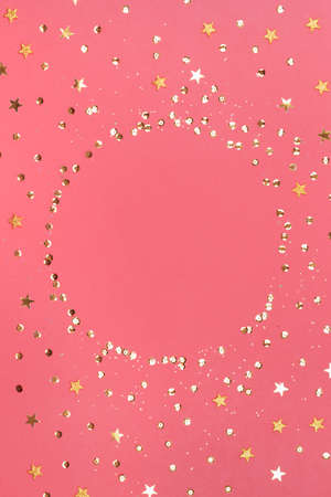 Pink background with glitter and golden stars. Sparkling texture. Festive backdrop for your...