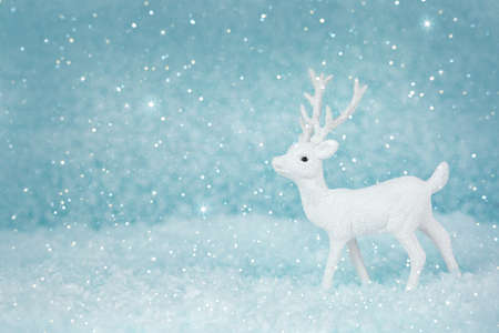 Christmas deer on a snowy background. New year card. Xmas concept with copy space.の写真素材