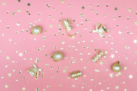 Pink background with glitter, golden stars and decorations. Sparkling texture. Festive backdrop for your projectsの写真素材