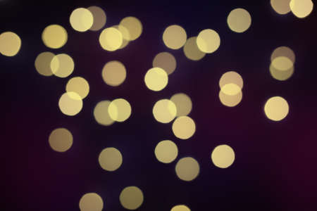 Golden bokeh background. Colored bright blurred texture of lightsの写真素材