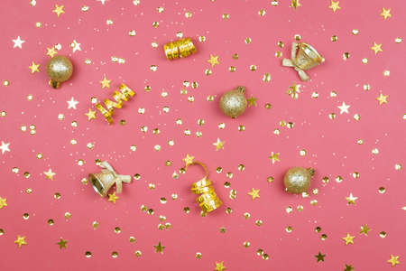 Coral background with glitter, golden stars and decorations. Sparkling texture. Festive backdrop for your projectsの写真素材