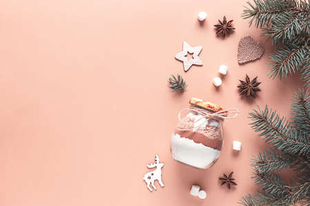 Edible Christmas gift in a glass jar for making a chocolate drink on a beige background. New year presents. Xmas treatsの写真素材