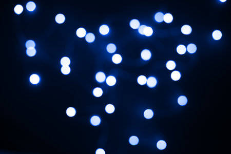Bokeh background. Blue bright blurry textures of lights on a dark backdropの写真素材
