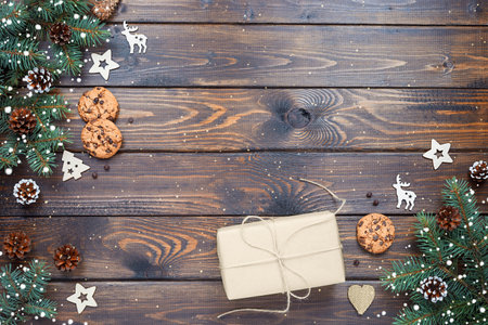 Christmas background with gift box, Chocolate chip cookies and wooden decorations. Eco friendly, zero waste. New year's backdrop. Flat lay, top view. Copy space.の写真素材