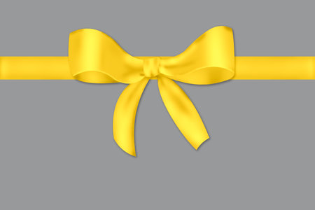 Yellow bow and ribbon on a gray background. Gift box. Trendy colors 2021.の写真素材