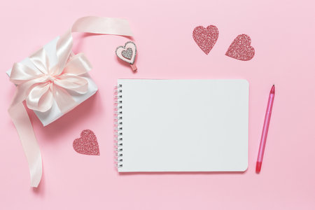 A gift and an empty space to congratulate on Valentine's Day, birthday, Mother's Day or International Women's Day on a pink background. A congratulatory letter.の写真素材