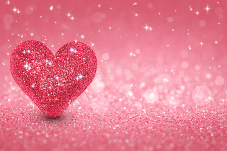 Love sparkling Valentine's day background with pink heart. Holiday greeting card.の写真素材