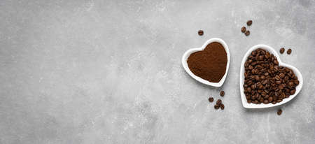 Coffee beans, ground coffee in white plates on a gray background. Top view, copy space. Bannerの写真素材