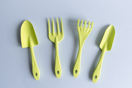 A set of garden tools in green color on a gray background. Flat lay.の写真素材