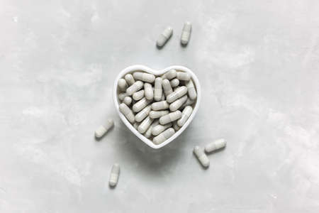Collagen tablets on a gray background with a copy space. Natural beauty and health supplement.の写真素材