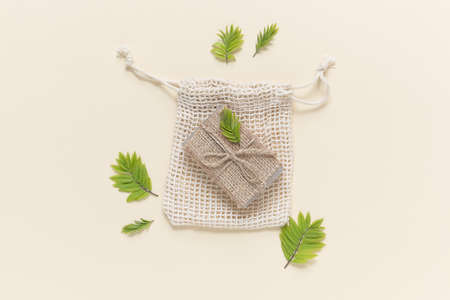 Eco friendly natural solid soap in natural packaging on a beige background. Zero waste concept. Plastic free. Flat lay, top viewの写真素材