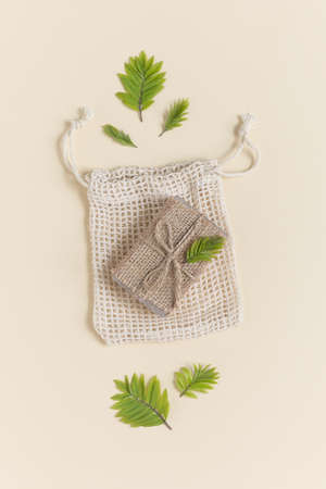 Eco friendly natural solid soap in natural packaging on a beige background. Zero waste concept. Plastic free. Flat lay, top viewの写真素材