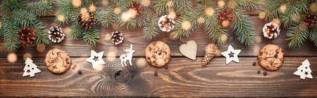 Christmas background with Chocolate chip cookies and wooden decorations. Eco friendly, zero waste. New years backdrop. Flat lay, top view. Copy space. Bannerの写真素材