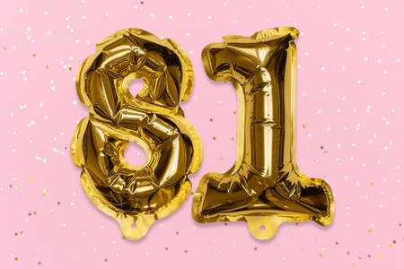 The number of the balloon made of golden foil, the number eighty-one on a pink background with sequins. Birthday greeting card with inscription 81. Numerical digit, Celebration event, template.の写真素材