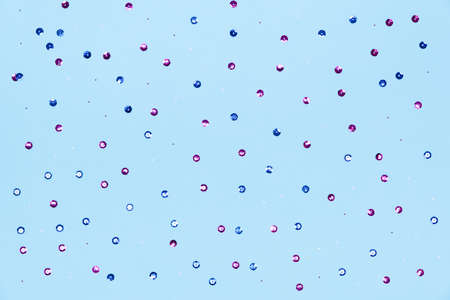 Blue background with colored sequins and shiny sequins. Suitable for backdrop for your design. Top view, copy space. Template.の写真素材