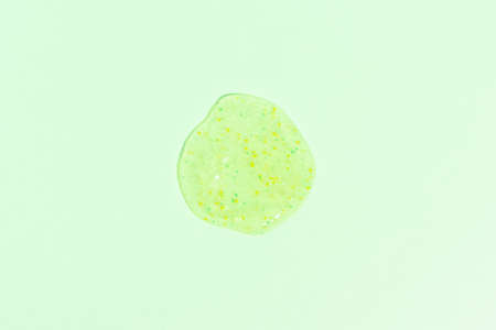A smear, a drop of scrub on a green background. Beauty concept. Selective focus.の写真素材