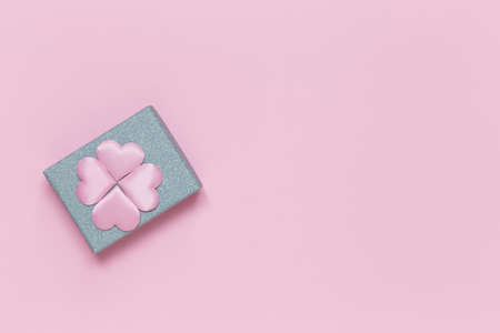 Silver gift box with decorative hearts on a pink background. Gift for Valentine's Day, Birthday, Mother's Day or International Women's Day.の写真素材