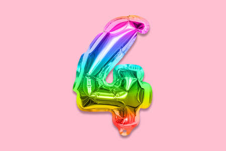 Rainbow foil balloon number, digit four on a pink background. Birthday greeting card with inscription 4. Top view. Numerical digit. Celebration event template.の写真素材