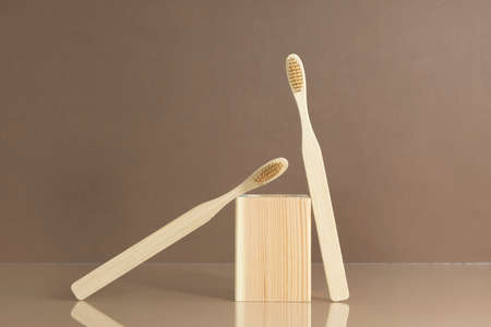 Eco-friendly bamboo toothbrushes on a brown background. Natural organic bathroom beauty product concept.の写真素材
