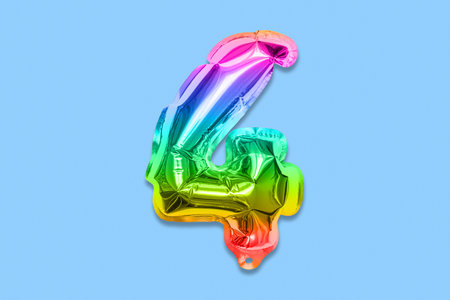 Rainbow foil balloon number, digit four on a blue background. Birthday greeting card with inscription 4. Top view. Numerical digit. Celebration event template.の写真素材