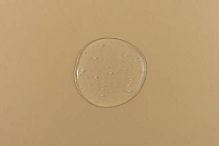 The texture of serum or oil on a beige background. wellness and beauty concept.の写真素材