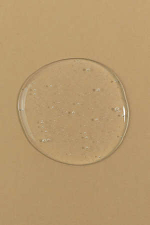 The texture of serum or oil on a beige background. Wellness and beauty concept.の写真素材