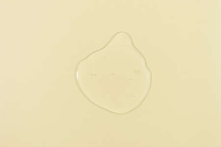 The texture of serum, oil, hyaluronic acid or gel on a yellow background. wellness and beauty concept.の写真素材