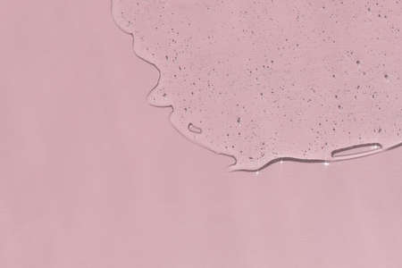 Antibacterial gel on a pink background. Serum or hyaluronic acid. Virus protection or cosmetics concept.の写真素材
