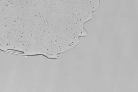 Antibacterial gel on a gray background. Serum or hyaluronic acid. Virus protection or cosmetics concept.の写真素材
