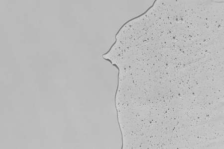 Antibacterial gel on a gray background. Serum or hyaluronic acid. Virus protection or cosmetics concept.の写真素材