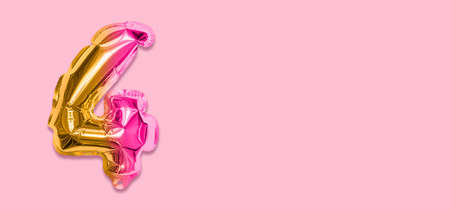 Rainbow foil balloon number, digit four on a pink background. Birthday greeting card with inscription 4. Top view. Numerical digit. Celebration event template. Banner.の写真素材