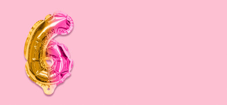 Rainbow foil balloon number, digit six on a pink background. Birthday greeting card with inscription 6. Top view. Numerical digit. Celebration event template. Banner.の写真素材