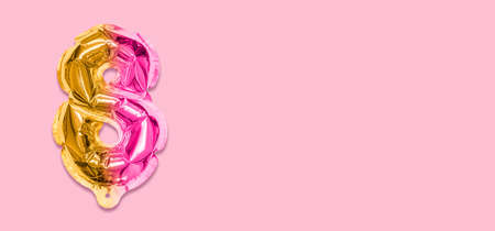 Rainbow foil balloon number, digit eight on a pink background. Birthday greeting card with inscription 8. Top view. Numerical digit. Celebration event template. Banner.の写真素材