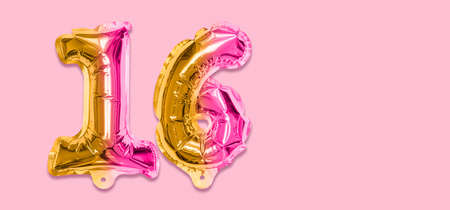 Rainbow foil balloon number, digit sixteen on a pink background. Birthday greeting card with inscription 16. Top view. Numerical digit. Celebration event template. Banner.の写真素材