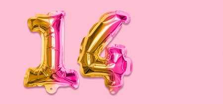 Rainbow foil balloon number, digit fourteen on a pink background. Birthday greeting card with inscription 14. Top view. Numerical digit. Celebration event template. Banner.の写真素材