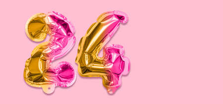 Rainbow foil balloon number, digit twenty four on a pink background. Birthday greeting card with inscription 24. Top view. Numerical digit. Celebration event template. Banner.の写真素材
