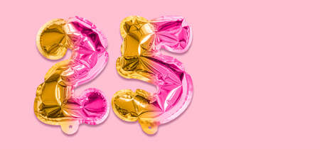 Rainbow foil balloon number, digit twenty five on a pink background. Birthday greeting card with inscription 25. Anniversary concept. Numerical digit. Celebration event template. Banner.の写真素材