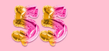 Rainbow foil balloon number, digit fifty five on a pink background. Birthday greeting card with inscription 55. Anniversary concept. Numerical digit. Celebration event template. Banner.の写真素材