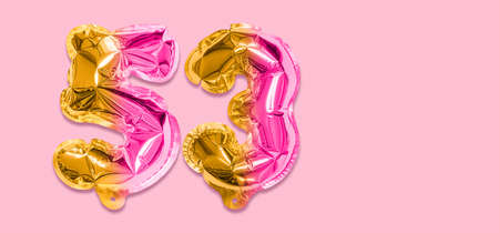 Rainbow foil balloon number, digit fifty three on a pink background. Birthday greeting card with inscription 53. Top view. Numerical digit. Celebration event template. Banner.の写真素材