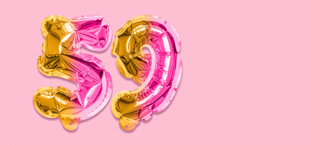 Rainbow foil balloon number, digit fifty nine on a pink background. Birthday greeting card with inscription 59. Top view. Numerical digit. Celebration event template. Banner.の写真素材