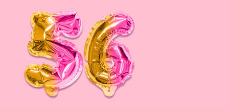 Rainbow foil balloon number, digit fifty six on a pink background. Birthday greeting card with inscription 56. Top view. Numerical digit. Celebration event template. Banner.の写真素材